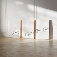 three drawings on the wall next to each other in a room with hard wood flooring