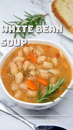 white bean soup in a bowl with bread on the side and rosemary garnish