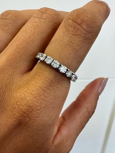 a woman's hand with a diamond ring on it