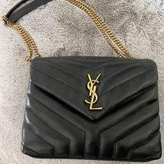 New Never Used Saint Laurent Shoulder Bag In Overstitched Y-Quilted Calf Leather. Sliding Chain And Leather Shoulder Strap May Be Doubled; Folded, 11.8" Drop And Unfolded, 22" Drop. Bronze Metal Hardware. Envelope Flap With Ysl Logo; Snap Closure. Center Zip Pocket Divides Interior; One Slip Pocket. Grosgrain Lining. 6.6"H X 9.8"W X 3.5"D. Approx. Weight 2.1 Lb. Made In Italy. Ysl Loulou Bag, Wishlist 2024, Ysl Logo, Bronze Metal, Saint Laurent Bag, Clothing Ideas, Metal Hardware, Designer Bags, Ysl Bag