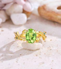 a green ring sitting on top of a white rock