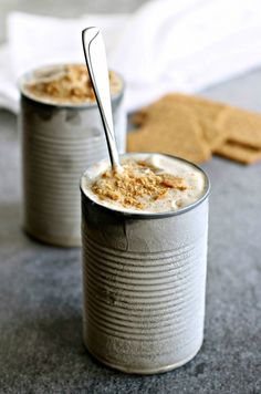 two tins filled with food sitting on top of a table