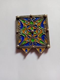 This product is a piece of jewelry that is distinguished by its square shape, engraved with beautiful colors, and made of silver. It represents one of the African, Moroccan, Berber jewelry. It can be worn on all occasions. Artisan Sterling Silver Square Pendant Jewelry, Sterling Silver Rectangular Pendant Jewelry Gift, Ceremonial Enamel Pendant Jewelry, Artisan Jewelry For Festivals And Gifts, Artisan Jewelry For Festivals Or Gifts, Ceremonial Blue Enamel Jewelry, Green Jewelry For Festivals And Gifts, Yellow Enamel Jewelry For Gift, Unique Silver Rectangular Pendant Jewelry