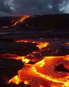 lava flowing down the side of a mountain at night