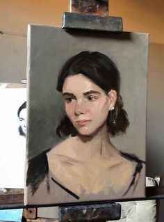 an oil painting of a woman's face on a easel