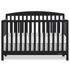 a black crib with white sheets on the bottom and side rails, in front of a