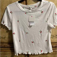 Brand New Cute Top With Embroidered Cherries On A Knit Type Fabric Consisting Of 65%Polyester 30% Rayon And 5% Spandex Fitted White Top With Cherry Print, Fitted White Cherry Print Top, Fitted Cherry Print Tops For Spring, Fitted Casual Tops With Cherry Print, Fitted Casual Cherry Print Tops, Casual White Cherry Print Tops, Red Cherry Print Tops For Spring, Red Cherry Print Top For Spring, Casual Red Cherry Print Tops