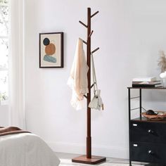 a coat rack in the corner of a bedroom