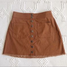 An Easy A-Line Skirt With A Cutoff Hem For A Diy Feel. Patch Pockets And Snaps Give It A Cool Old-School Vibe(Just Right With A Striped Tee Or Tank) Cotton-Elastane Machine Wash Import Brown Cotton Mini Skirt With Pockets, Brown Cotton Mini Skirt For Summer, Casual Brown Button-up Bottoms, Brown Mini Skirt With Pockets For Spring, Spring Button-up Brown Skirt, Casual Brown Skirt With Buttons, Brown Button Closure Skirt For Summer, Spring Brown Mini Skirt With Pockets, Brown Skirt With Button Closure For Summer