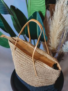 This stylish and sustainable Boho Living Straw Tote Bag is perfect for all your beach day needs! Made from natural jute, this tote is sure to turn heads with its neutral hues. No more lugging around your beach gear - pack it up in this tote bag for a fashionable way to hit the waves! Beachy Sand-colored Beach Bag With Braided Handles, Spring Beach Sand-colored Straw Bag, Beachy Sand-colored Straw Bag, Beige Double Handle Beach Bag With Adjustable Strap, Eco-friendly Lightweight Bags For Beach Season, Sand-colored Bags With Braided Handles For Daily Use, Eco-friendly Bag With Adjustable Strap And Natural Fiber, Eco-friendly Bags With Adjustable Strap, Sand-colored Travel Bags For Beach Season