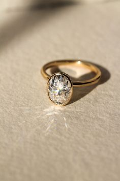 a diamond ring sitting on top of a table