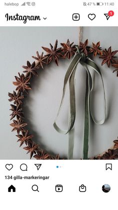 the instagram page shows an image of a wreath made out of pine cones and ribbons