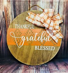 a wooden sign with a bow on it that says, thank grateful and is decorated with plaid