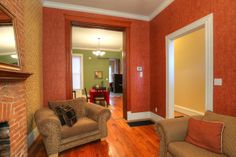 a living room with two couches and a fire place in the middle of it