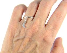 "This sterling silver crescent charm ring has a beautiful 9x6mm sterling silver half moon charm dangling from a sterling silver band. ✦100% handcrafted ✦ High quality sterling silver metal ✦ Arrives in a beautiful cotton-filled white or pink gift box and tied with a black or pink bow and an optional complimentary pastel colored gift card ✦ Ready to ship in one business day ✦ Average shipping time in the U.S. is three to five business days ✦ Tracking available ✦.925 sterling silver crescent moon Minimalist Adjustable Moon-shaped Jewelry, Minimalist Crescent Moon Charm Ring, Minimalist Adjustable Crescent Ring, Minimalist Moon-shaped Adjustable Jewelry, Dainty Adjustable Moon-shaped Midi Rings, Minimalist Adjustable Moon Phase Rings, Dainty Adjustable Moon Shape Midi Rings, Minimalist Sterling Silver Moon Midi Rings, Adjustable Minimalist Moon Midi Rings