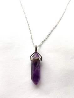 "Amethyst Crystal Pendant Necklace  Chain is silver plated 18inches  ‼️ Please note each stone varies as these are natural stones neither all are the same‼️ \"The necklace of peace\" Amethyst is known for its healing powers, it has the ability to attract spiritual energies and to calm restless thoughts. As it provides peace of mind, it is a good stone for meditation and to promote serene dreams. Amethyst is a very powerful and protective Crystal, is was used ancient times to recover from addicti Amethyst Crystal Pendant Gift, Mystical Purple Pendant Crystal Necklace, Purple Amethyst Pendant Crystal Necklace, Wire Wrapped Crystal Pendant, Spiritual Amethyst Pendant Gemstone, Spiritual Amethyst Crystal Pendant, Lapis Lazuli Crystal, Quartz Crystal Pendant, Turquoise Crystal