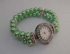 This is a stunning glass pearl 2 strand beaded wrist watch.  The pearls are 8 mm and are set in two rows with diamanti spacers dividing the rows and the face also has diamanti's around it.  the watch fits an average 20 cm but as it's elasticated it can be adjusted if you let me know on purchase what size you wold like as I make these to order. I can also make these in more colours but of you don't see what you would like please message me and I will see what beads  I have in stock.  Comes in a velvet pouch making a perfect gift or treat. Ivory Necklace, Ladies Wrist Watch, Beaded Watches, Green Watch, Fabric Bracelets, Fob Watch, Green Pearls, Christmas Gifts For Women, Watch Gifts