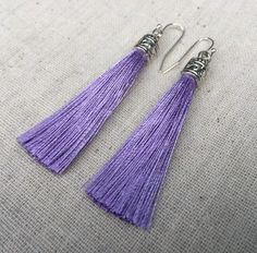 "Chic light purple tassel earrings! They would add a pop of color to any outfit for any occasion. Dress them up or down. They are timeless and versatile. They are lightweight, fun and unique! The tassels measure 2 1/8\" long by 1/4\" wide. They hang from simple silver ear wire hooks. Overall drop length is about 2 1/4\". Metal is allergy free plated silver. These are my latest creation! I have them available in many colors! Find them all under the category tassel earrings in my shop. Thanks for Handmade Purple Tassel Earrings As Gift, Handmade Purple Tassel Earrings For Gift, Purple Tassel Drop Earrings With Dangling Beads, Purple Tassel Earrings With Dangling Beads For Gift, Elegant Handmade Purple Tassel Earrings, Purple Dangle Earrings With Tassels, Handmade Purple Dangle Tassel Earrings, Handmade Elegant Purple Tassel Earrings, Purple Dangle Tassel Earrings