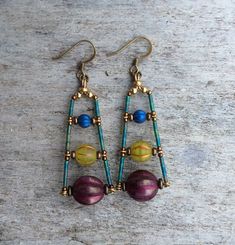 two pairs of earrings with beads on them