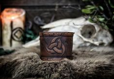 Leather cuff bracelet with the Three Horns of Odin, made of premium leather. The original design of Odin's horns is carefully embossed on the piece, which has been subjected to a handmade aging process identical to those used in Hollywood movies so that the piece seems directly drawn from an epic fantasy story. The size of the laced version ranges from 15 to 22 cm If your size varies from these measures please contact us before buying. The price is for a single bracer. Handmade Viking Leather Bracelet, Horns Of Odin, Viking Pattern, Leather Bracers, Bracelet Viking, Leather Armor, Hollywood Movies, Leather Cuff Bracelet, Fantasy Story