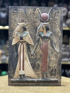 an ancient egyptian scene with two women holding hands