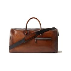 Berluti's duffle bag is crafted from the brand’s signature Venezia leather, unique for its smooth, glossy finish and dappled tone, and is etched with a recognisable ‘Scritto’ motif inspired by an 18th century letter bought at auction by the founder. The generously sized proportions make it a sensible choice for travel. Attach the shoulder strap to carry heavy loads more comfortably. Elegant Textured Leather Weekender Bag, Elegant Textured Leather Duffle Bag For Daily Use, Elegant Textured Leather Business Duffle Bag, Elegant Business Duffle Bag With Textured Leather, Elegant Textured Leather Duffle Bag For Business Trips, Luxury Textured Leather Weekender Bag For Business, Elegant Formal Weekender Bag With Smooth Grain, Luxury Textured Leather Business Weekender Bag, Elegant Weekender Bag With Smooth Grain For Formal Use