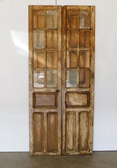 an old pair of wooden doors with glass inserts