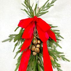 a christmas wreath with bells and red ribbon