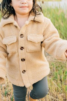 Keep your little one cozy + stylish with the Sherpa Shacket. This adorable shacket is designed for babies + toddlers up to 5T, providing warmth + comfort during chilly days. Made from soft + plush sherpa material, it is gentle on delicate skin. The shacket features a trendy design that can be easily layered over any outfit, making it a versatile addition to your child's wardrobe. 100% Cotton Wash in cold water, Tumble dry low. Runs oversized, size down one size! Length: 0-3m 11, 3-6m 11.75, 6-12m 12.25, 18m 13.25, 2T 14.25, 3T 16, 4T 16.75, 5T 17.5 width: 0-3m 11, 3-6m 11.5, 6-12m 12, 18m 12.5, 2T 13.5, 3T 14.25, 4T 15.25, 5T 16.25 Sherpa Shacket, Baby Luna, Diaper Bag Accessories, French Baby, Toddler Fall, Swimming Outfit, Outfit Making, Organic Clothing, Baby Cold