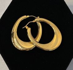 Add a touch of elegance to your look with these stunning 14kt Yellow Gold Oblong Hoop Earrings. Crafted with high-quality materials, these earrings are perfect for any occasion. Whether you're dressing up for a night out or adding a pop of glamour to your everyday outfit, these hoops are a must-have accessory! Drop Length: 1 1/2 inches Weight: .28 oz Width: 1.6 inches Hoop Thickness: 4mm Hoop Width at smallest point: 5.1mm Hoop Width at largest point: 10mm IMPORTANT NOTICE:  We do not accept ret Classic 14k Gold Hoop Earrings For Evening, Classic Yellow Gold Hoop Earrings For Evening, Classic Polished Hoop Earrings For Evening, Elegant Hoop Earrings With Shiny Finish For Gift, Elegant Hoop Earrings With Shiny Finish, Elegant Shiny Finish Hoop Earrings For Gift, Modern Gold Hoop Earrings For Evening, Elegant Gold Plated Hoop Earrings With Shiny Finish, Luxury Teardrop Hoop Earrings With Polished Finish