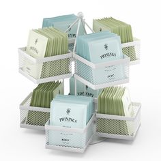 a stack of tea bags sitting on top of each other in white baskets next to each other