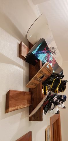 there is a snowboard hanging on the wall next to some skis and gloves