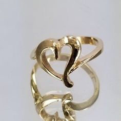 14k Gold Ring with a heart in the center. For only $289.00. Purchase comes with a gift box included. Ring size is adjustable, please note the size in the personalization section of checkout. 14k Gold Heart Ring With Polished Finish For Wedding, Heart Shaped Open Ring With Polished Finish For Wedding, Elegant Adjustable Heart Ring, Wedding Heart Ring With Polished Open Ring Finish, Wedding Heart Ring With Polished Open Design, Adjustable Gold Heart-shaped Initial Ring, Adjustable Gold Heart Initial Ring, Adjustable Elegant Heart Cut Ring, Elegant Heart Ring With Polished Finish For Wedding