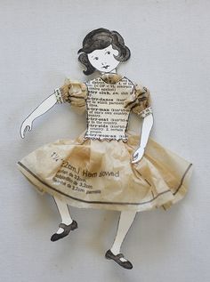 a piece of paper cut out to look like a girl in a dress with words written on it