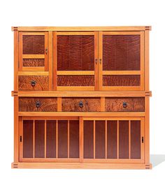 a wooden cabinet with many drawers and doors on it's sides, against a white background