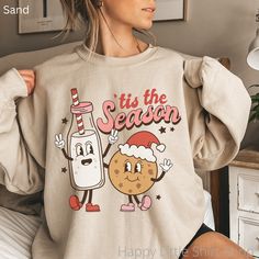 "Retro Tis The Season Sweatshirt, Cookies and Milk Sweatshirt, Retro Christmas Sweatshirt,  Hippie Apparel, Hippie Christmas, Holiday Apparel, Holiday Apparel for Women, Mom Christmas Sweatshirt, Bestfriend Christmas Gift, Funny Christmas Sweatshirt These sweatshirts are so soft and comfortable! They are perfect to wear this Holiday season! For an oversized look, order a size or two up from your normal size. Materials: 50% cotton, 50% polyester Medium-heavy fabric (8.0 oz/yd² (271.25 g/m Loose fit Sewn-in label Runs true to size Sizing: These are unisex sweatshirts so they fit a bit looser than women's sweatshirts. Please refer to the size chart image in the listing. I recommend taking one of your favorite sweatshirts and measuring it while it's laying flat. Our size chart measurements are Cute Holiday Crew Neck Sweatshirt, Cute Crew Neck Sweatshirt For Holiday, Cute Christmas Graphic Print Sweatshirt, Cute Christmas Sweatshirt With Graphic Print, Best Friend Christmas Gifts, Santa Sweater, Colorful Sweatshirt, Winter Pullover, Sweater Vintage