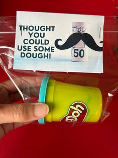 a hand holding a cup with a mustache on it and a sign that says thought you could use some doughnuts