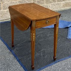 a small wooden table sitting on top of a rug