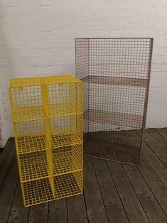 two yellow cages sitting on top of a wooden floor