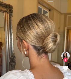 a woman with blonde hair is looking at herself in the mirror and has her photo taken