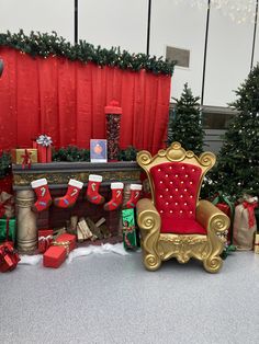 a red chair sitting in front of a christmas tree