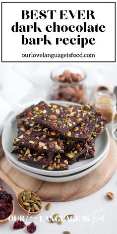 the best ever dark chocolate bark recipe on a plate with nuts and cranberries