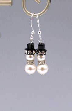 "I made these adorable TINY snowman earrings with 6mm and 8mm white glass pearls, clear and black rhinestone-studded spacers and jet black cubes as the top of their hats.  They measure 1 5/8 inches (4 cm) from the tops of their silver plated earwires.  If you prefer sterling silver long earwires for an additional $4.00 (see last photo), please choose that option at checkout. Please note:  These are MUCH smaller than they appear in the photos, which I enlarged to show the pretty details.  The pea Elegant White Earrings For Holiday, Elegant White Holiday Earrings, Tiny Snowman, Coffee Necklace, Bead Animals, Snowman Earrings, Small Snowman, Winter Earrings, Quirky Earrings