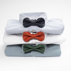 three bow ties are stacked on top of each other in different colors and sizes,