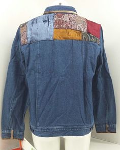 a denim jacket with patchwork on the back