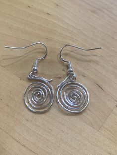 Handcrafted earrings.  Beautiful silver planished spiral earrings.  Unique design.  Sterling silver hooks.  Classy earrings!  Add some sparkle!  Size 20 mm drop. They make a lovely gift for that special person, or, why not treat yourself. Beautifully gift wrapped. Posted in a protective envelope. Free first class delivery within the UK. Returns and exchanges accepted within 3 days and returned within 7 days.  Exceptions may apply. Thank you for your interest and please look out for new designs. Classy Earrings, Spiral Earrings, Earrings Unique, Handcrafted Earrings, Jewelry Inspo, Special Person, Earrings Silver, Lovely Gift, Size 20