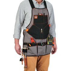 a man wearing an apron with tools attached to his chest and holding a wrench