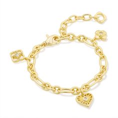 The Lacie Statement Charm Bracelet will be the conversation starter you won't want to take off. Featuring etched hearts and medallion shapes designed after the Kendra Scott logo, this contemporary take on the nostalgic jewelry trend is everything and more. To preserve your fashion jewelry for years to come, agents such as soaps, perfumes, lotions, makeup, hair and cleaning products, and other chemical contact should be avoided. Take care to remove jewelry before showering, sleeping, exercising o Kendra Scott Charm Bracelet, Trendy Gold Bracelets, Nostalgic Jewelry, Senior Szn, Piercing Inspo, Bracelets Collection, School Jewelry, Gold Bracelet Chain, Bracelet Collection