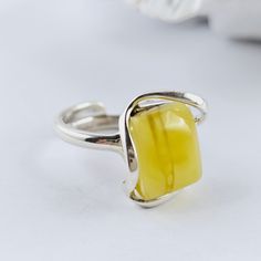 Unique Natural Baltic Amber Ring, White yellow Amber Ring, Amber And Sterling Silver Ring, Baltic Amber Jewelry, Amber Gift For Her, White yellow Amber Amazing adjustable ring made of natural Baltic amber and sterling silver. White Baltic Amber ring. Really stunning, Baltic amber ring in a beautiful white and yellow color. This handmade ring is made of 100% natural, polished Baltic amber and sterling silver. Weight: 7,43 g Dimensions: approx. 1,8 x 1,7 x 1 cm / 0.70 x 0.66 x 0.39 inch Size: adjustable Sterling silver 925 It's a handmade product, each item is unique. Great as a gift. Each of our products is packed in a beautiful gift box. Baltic amber manufacturer and seller from Poland. Our jewelry, beads and other goods shop: https://www.etsy.com/shop/FineBalticJewelry Shipping time to yo Yellow Sterling Silver Open Ring, Minimalist Yellow Sterling Silver Jewelry, Yellow Rectangular Anniversary Ring, Yellow Rectangular Ring As A Gift, Yellow Rectangular Ring For Gift, Yellow Open Ring Jewelry For Anniversary, Yellow Rectangular Rings For Gift, Yellow Adjustable Open Ring Jewelry, Adjustable Yellow Open Ring Jewelry