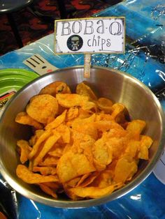 a bowl filled with chips sitting on top of a table